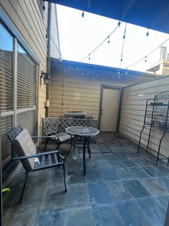 a view of a patio with table and chairs and wooden floor