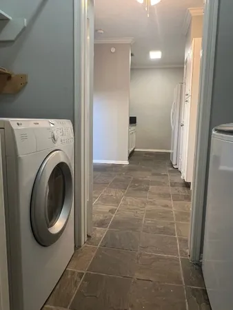 a view of a bathroom with washing machine and dryer