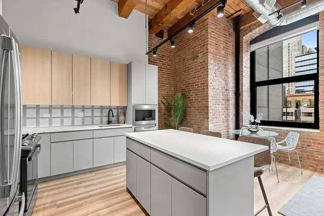 a kitchen with a stove and white cabinets