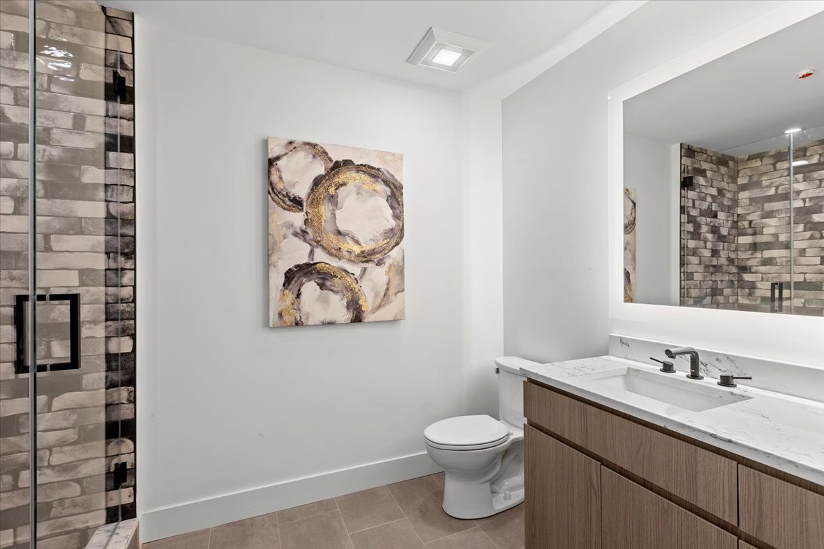 153 West Ohio Street, Unit 305 Chicago, IL 60654 - Photo 9 of 15 a bathroom with a toilet sink and mirror