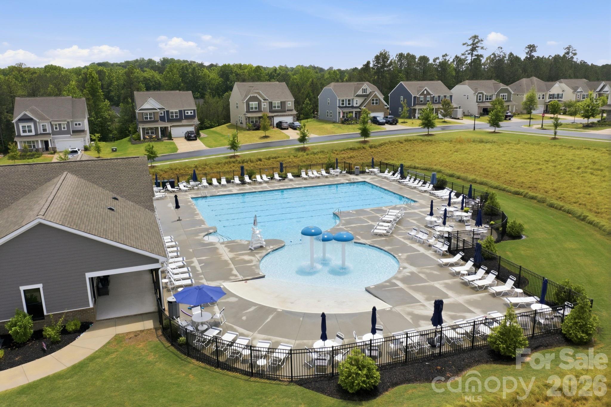 234 Hamptons Cove Road Troutman, NC 28166 - Photo 30 of 32 a view of a swimming pool with a yard