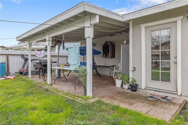 a view of a chair and table in backyard of the house