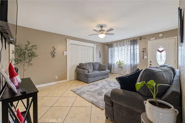 a living room with furniture and a potted plant