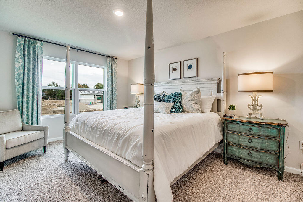 2837 Patriot Ridge Way Crestview, FL 32539 - Photo 12 of 35 a bedroom with a bed and lamp with window
