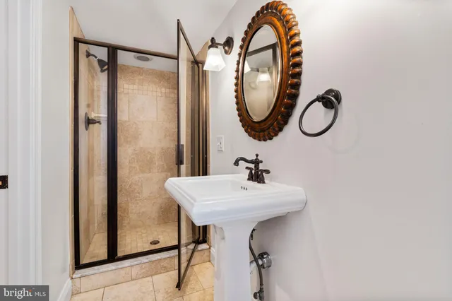 a bathroom with a sink mirror and tub