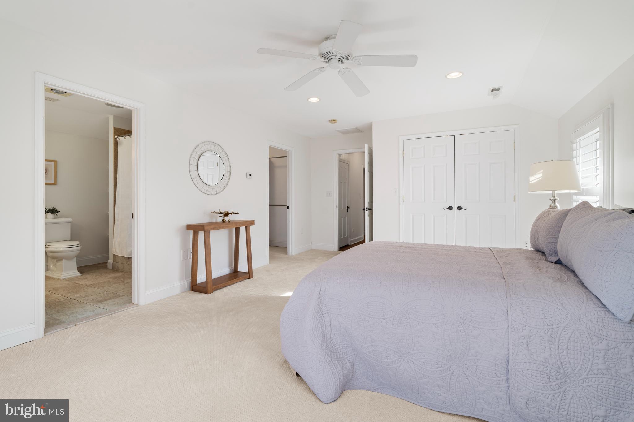 310 Worthington Road Baltimore, MD 21286 - Photo 22 of 50 a spacious bedroom with a bed and a lamp