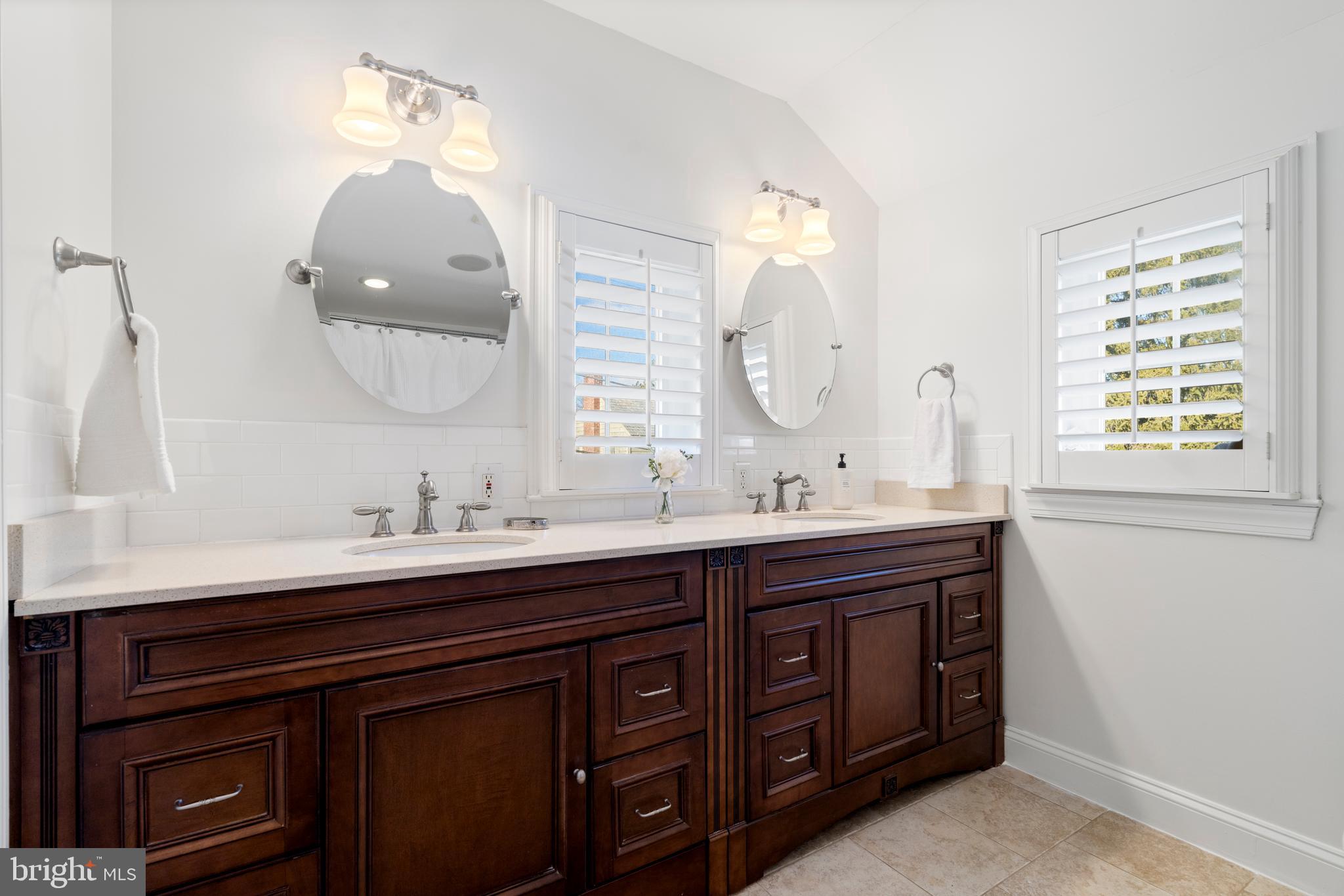 310 Worthington Road Baltimore, MD 21286 - Photo 23 of 50 a bathroom with a double vanity sink and a mirror