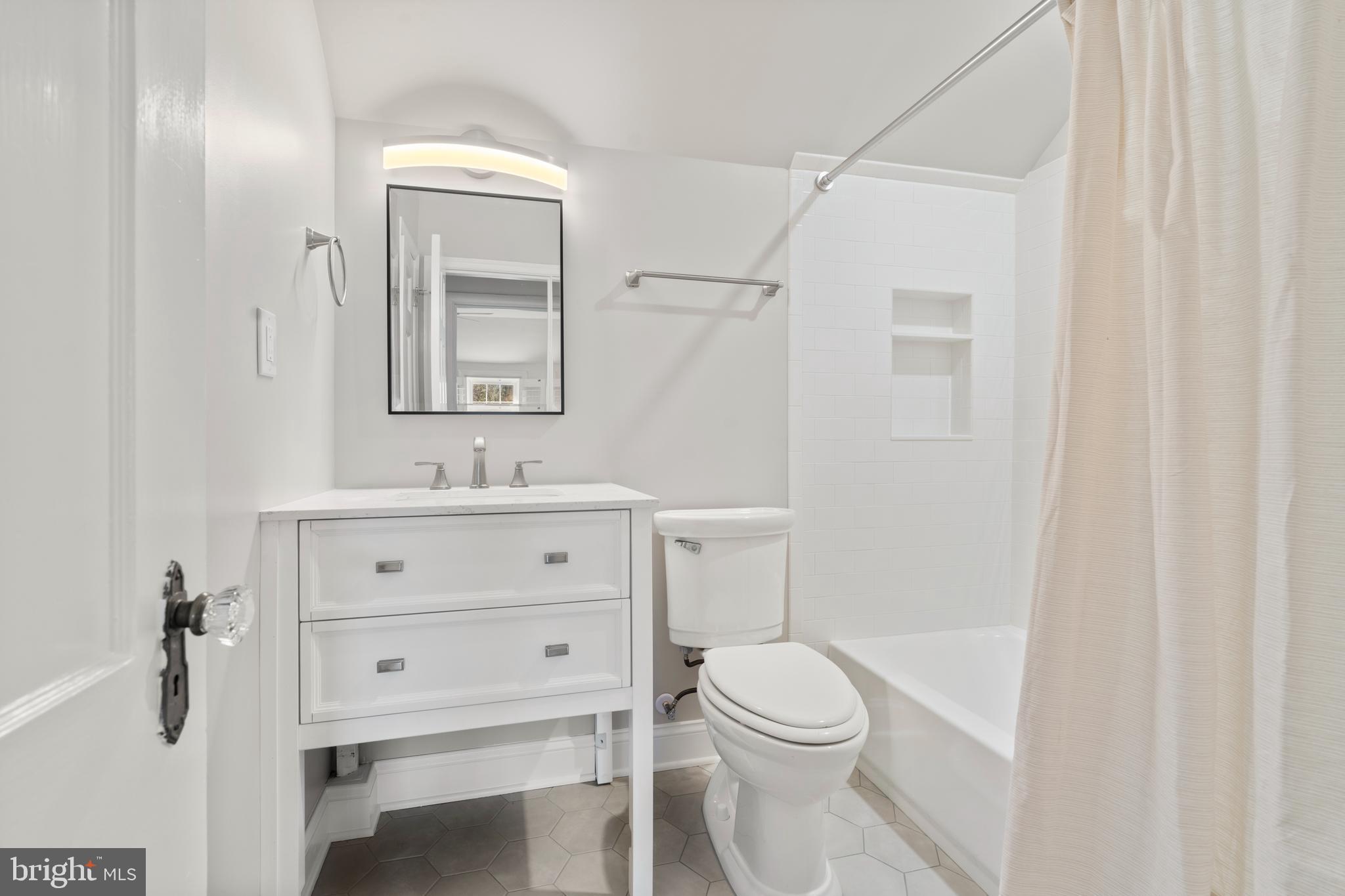 310 Worthington Road Baltimore, MD 21286 - Photo 29 of 50 a bathroom with a sink a toilet a mirror and shower