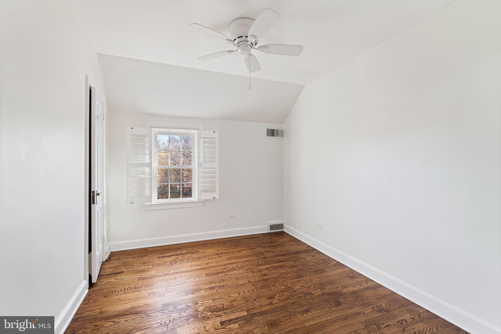 310 Worthington Road Baltimore, MD 21286 - Photo 31 of 50 an empty room with wooden floor ceiling fan and windows