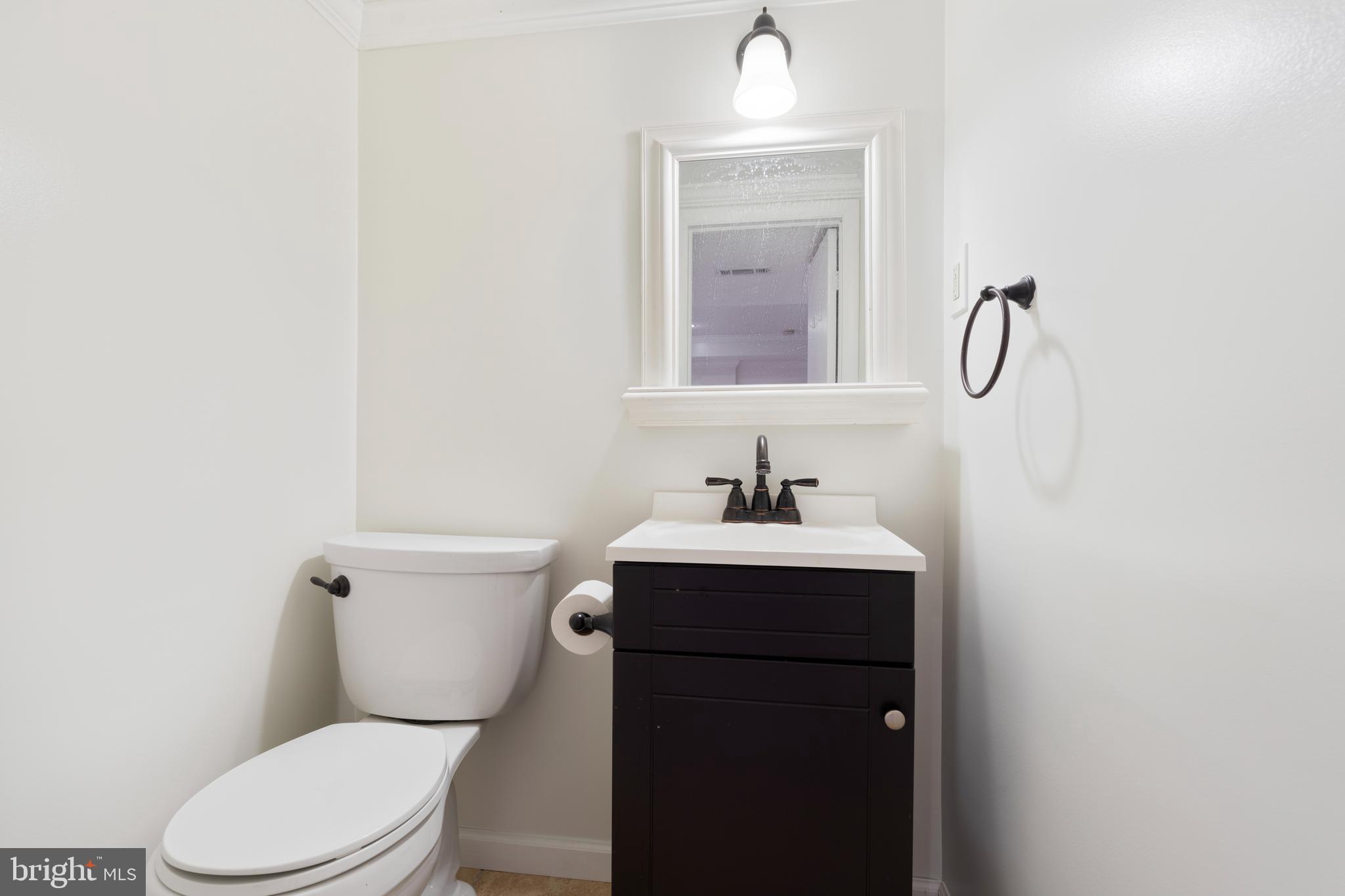 310 Worthington Road Baltimore, MD 21286 - Photo 37 of 50 a bathroom with a toilet sink and mirror