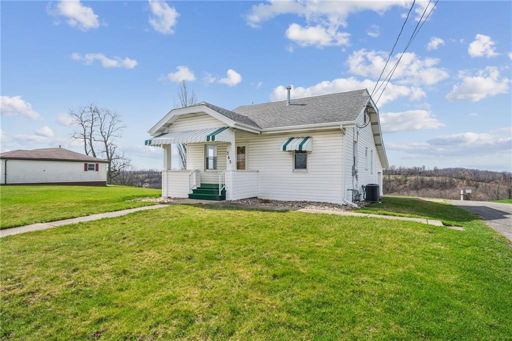 a front view of house with yard and porch