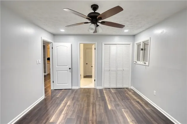 a view of empty room with wooden floor