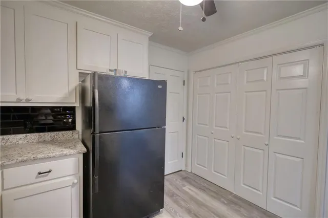 a white refrigerator freezer and a stove sitting inside of a kitchen