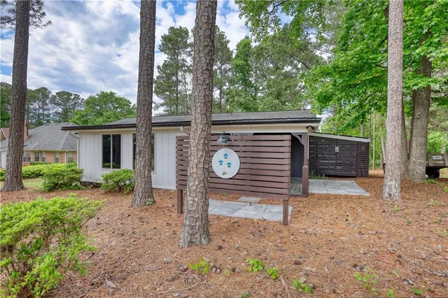 a wooden bench sitting in front of a house