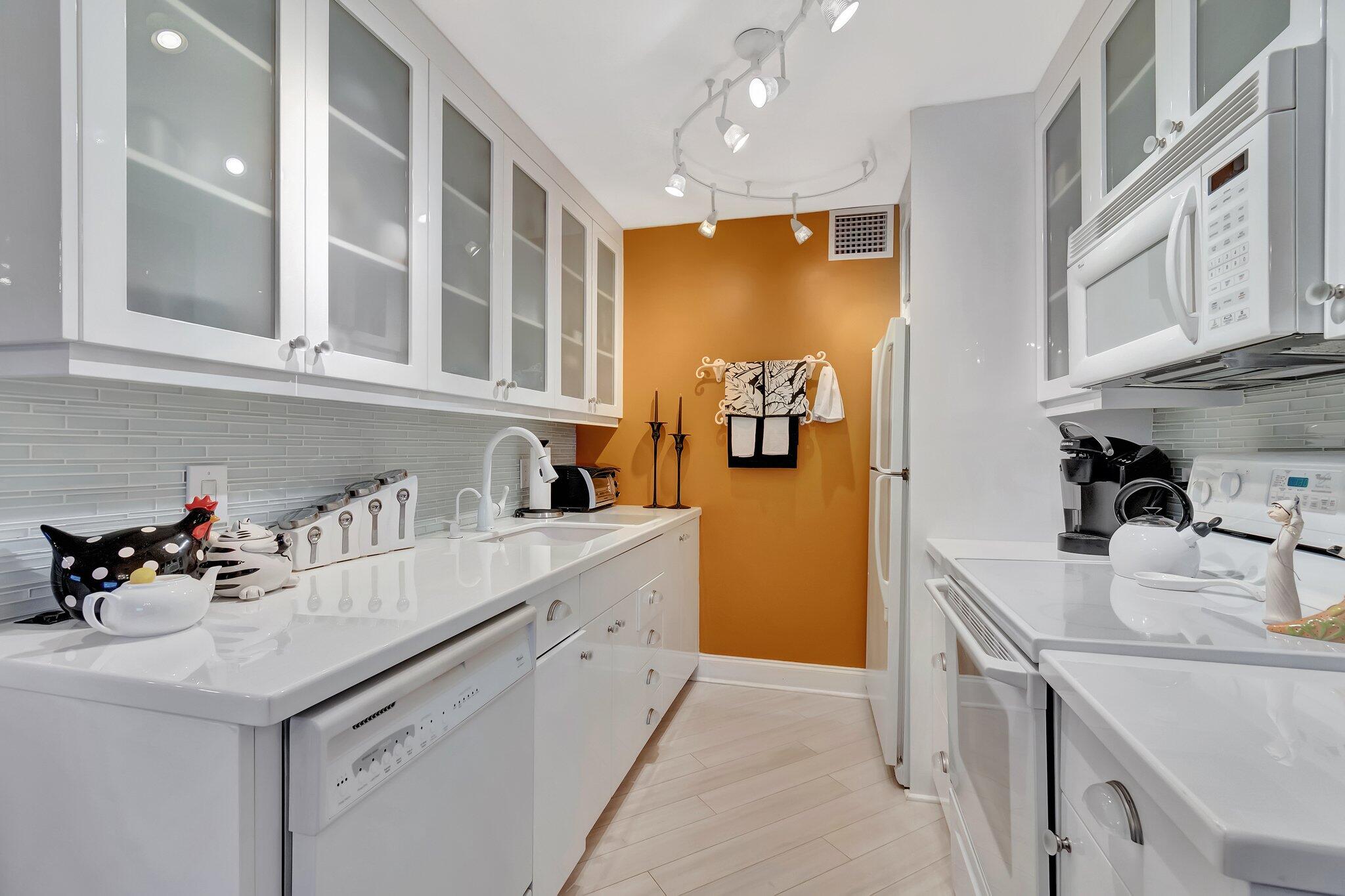 2026 Cornwall East Boca Raton, FL 33434 - Photo 18 of 82 a kitchen with granite countertop a sink stainless steel appliances and cabinets