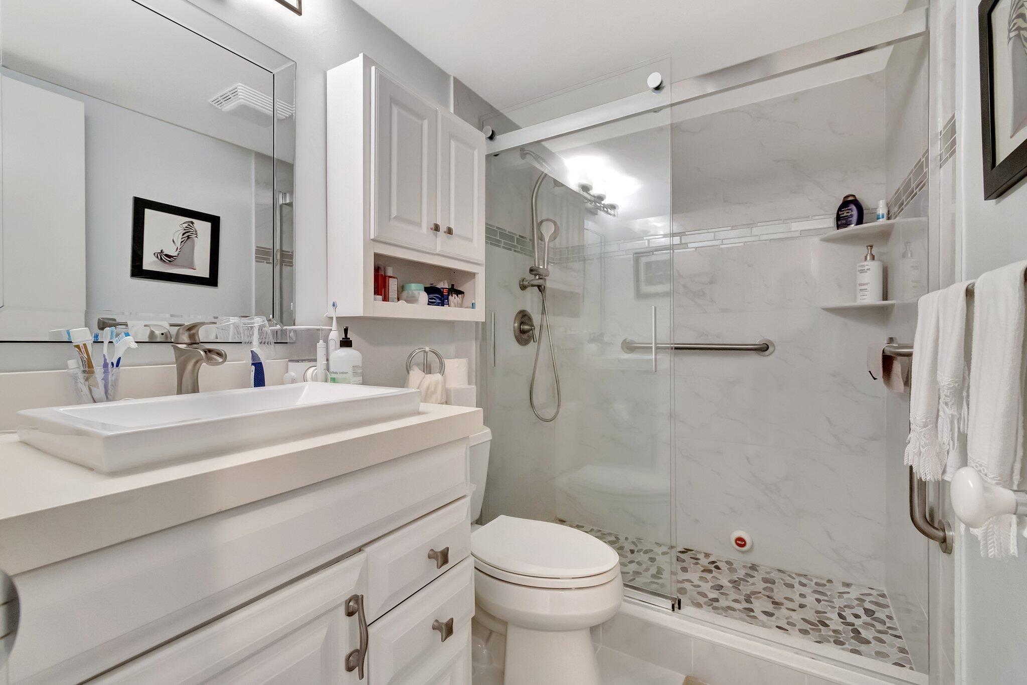 2026 Cornwall East Boca Raton, FL 33434 - Photo 21 of 82 a bathroom with a sink toilet a mirror and shower