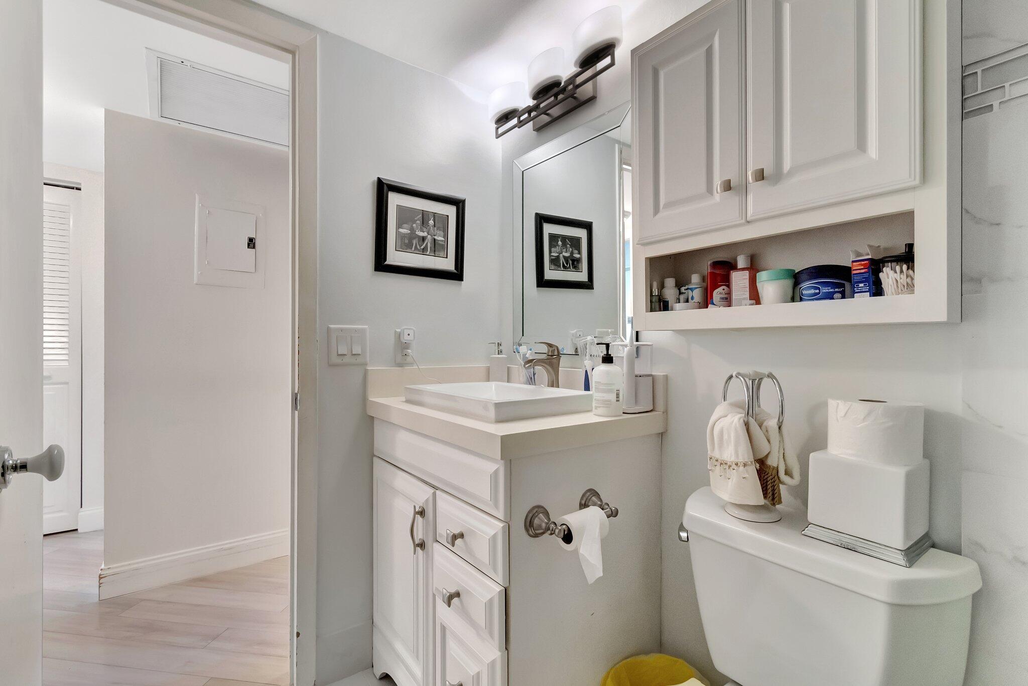 2026 Cornwall East Boca Raton, FL 33434 - Photo 22 of 82 a bathroom with a sink a toilet and a mirror