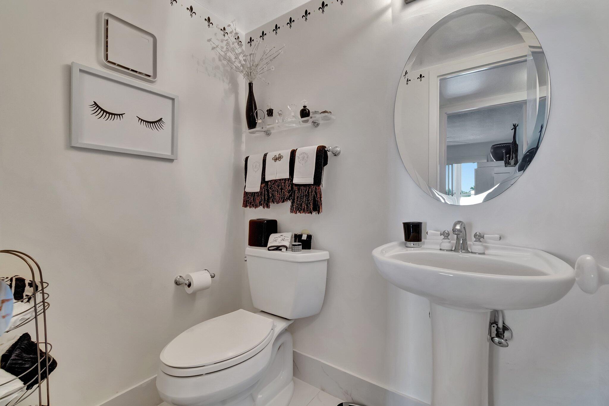 2026 Cornwall East Boca Raton, FL 33434 - Photo 27 of 82 a bathroom with a sink toilet and mirror