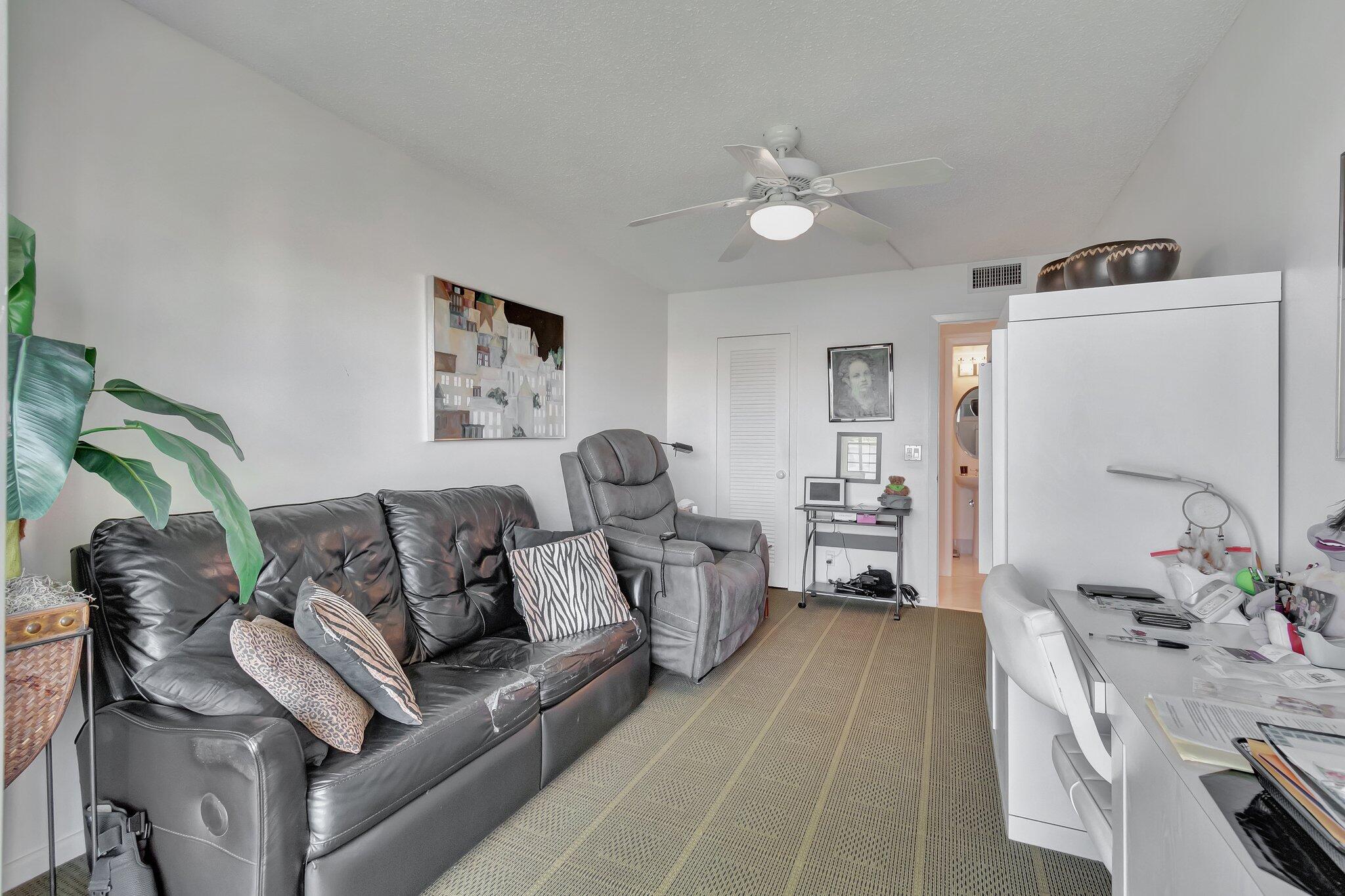 2026 Cornwall East Boca Raton, FL 33434 - Photo 31 of 82 a living room with furniture and a chandelier