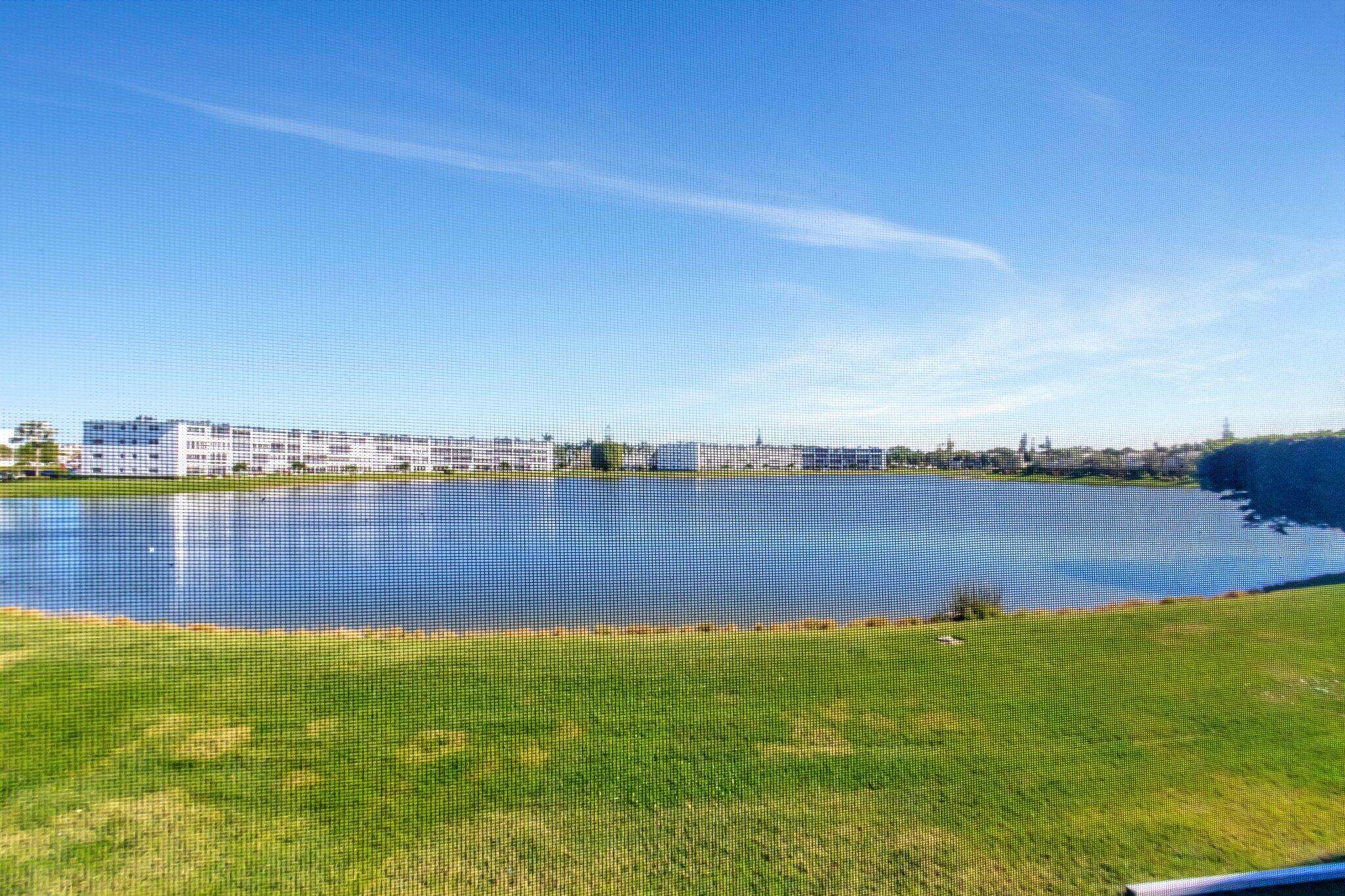 2026 Cornwall East Boca Raton, FL 33434 - Photo 37 of 82 a view of a lake with houses in the back