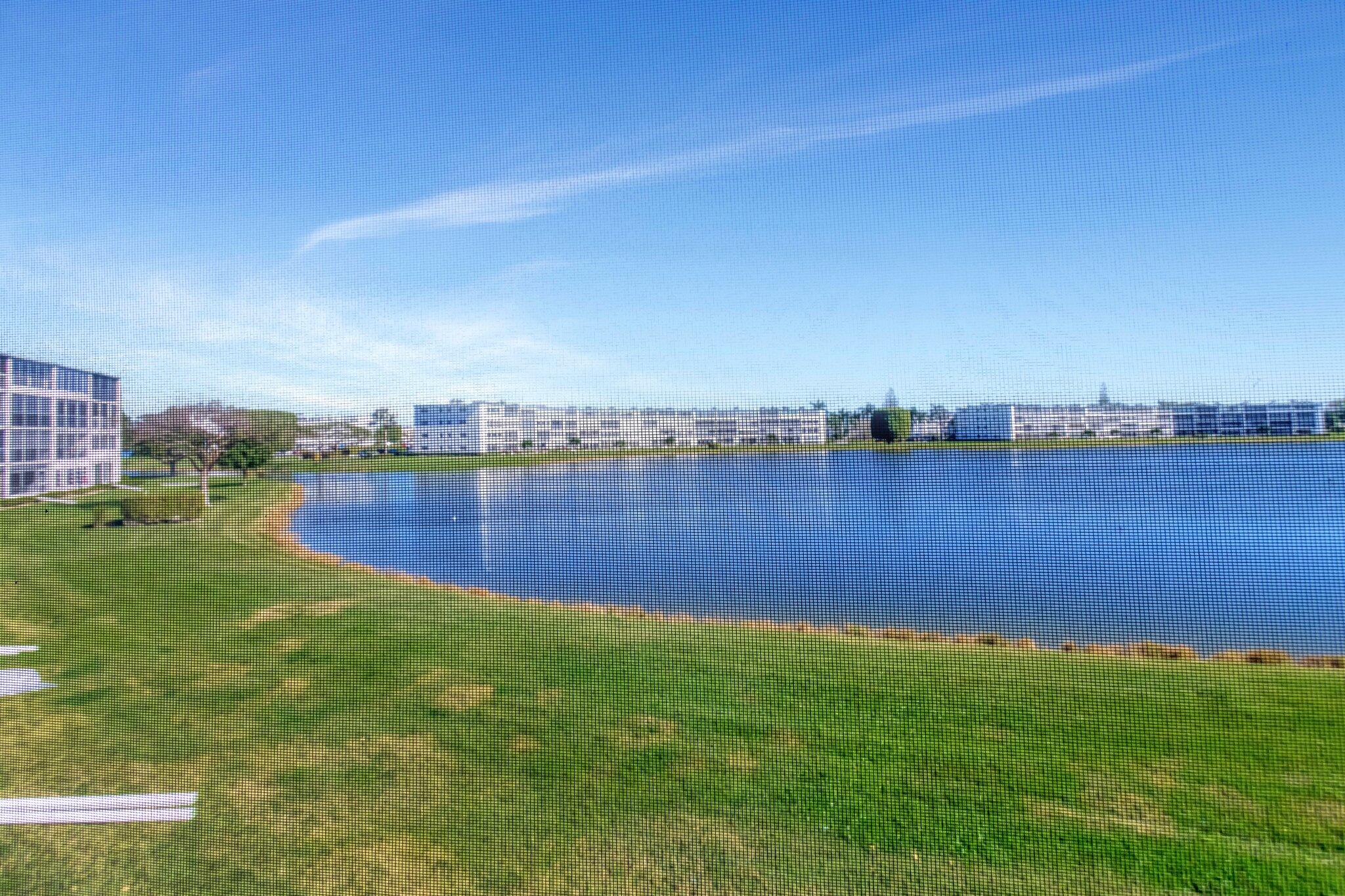 2026 Cornwall East Boca Raton, FL 33434 - Photo 38 of 82 a view of a lake with houses in the back