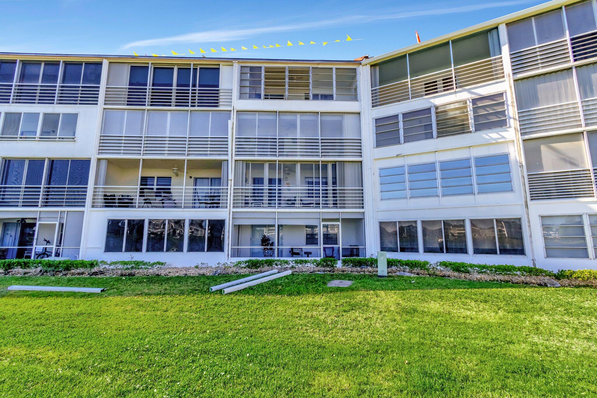 2026 Cornwall East Boca Raton, FL 33434 - Photo 42 of 82 a large building with a yard in front of it