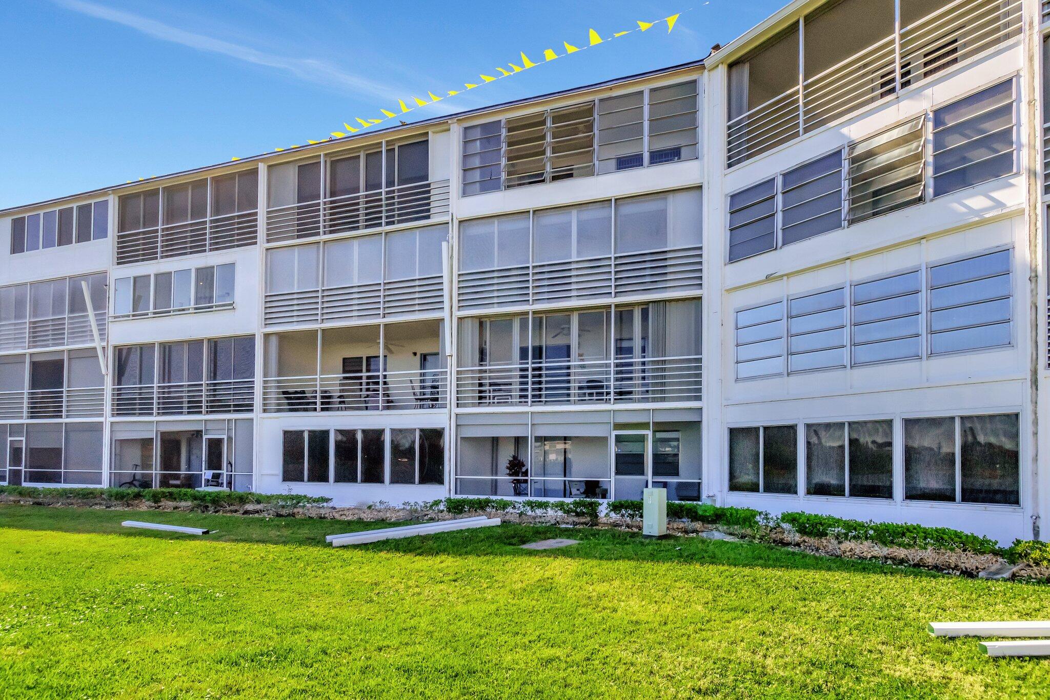 2026 Cornwall East Boca Raton, FL 33434 - Photo 43 of 82 a view of an apartment with a swimming pool and large trees