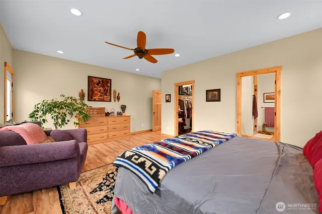 a bedroom with furniture and a large window