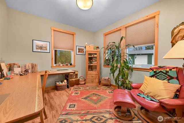 a bedroom with furniture and a flat screen tv