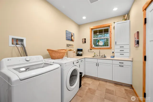 a view of washer and dryer with kitchen in the background