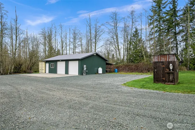 a view of a house with a yard and garage