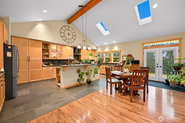 a large kitchen with a table and chairs in it