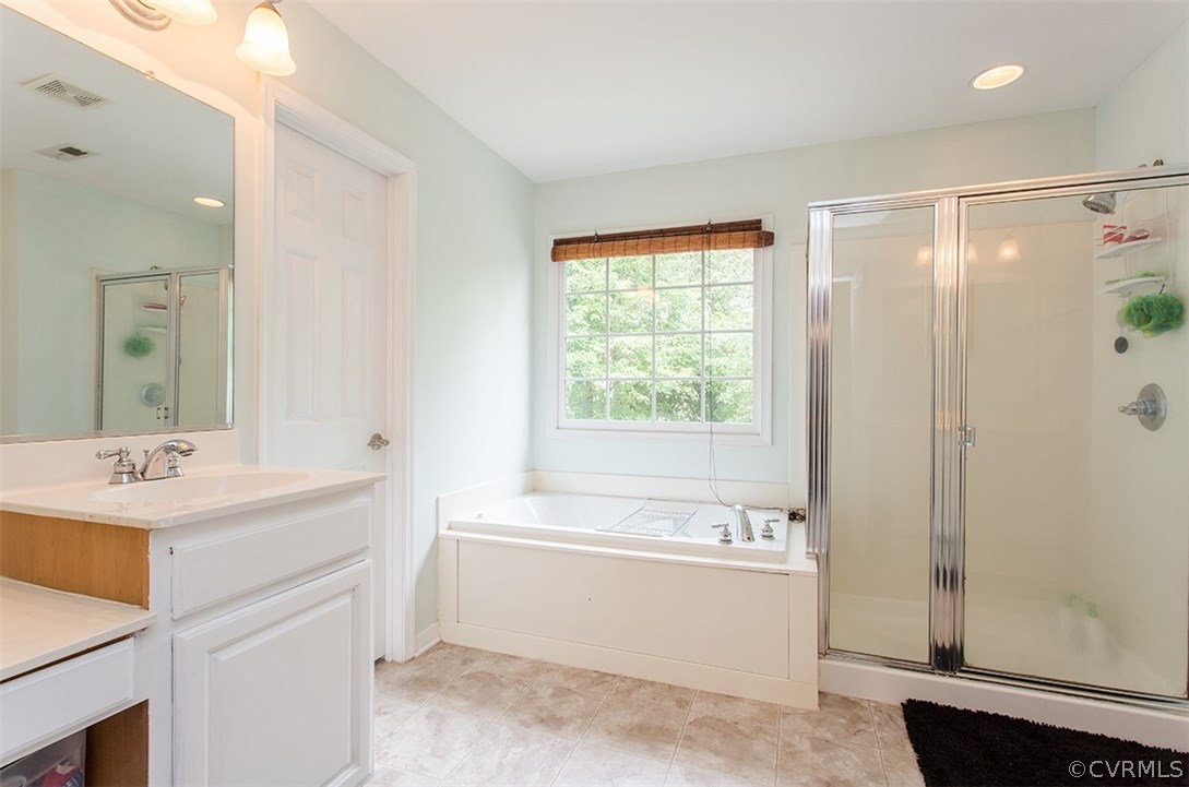 836 Club Ridge Terrace Chester, VA 23836 - Photo 21 of 27 a bathroom with a sink mirror and a bathtub