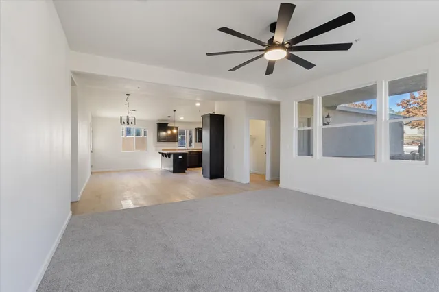 a view of an empty room with a ceiling fan