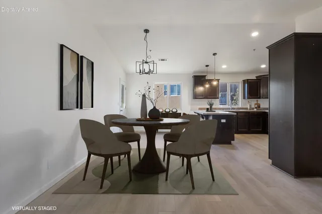 a view of kitchen with stainless steel appliances granite countertop cabinets and wooden floor