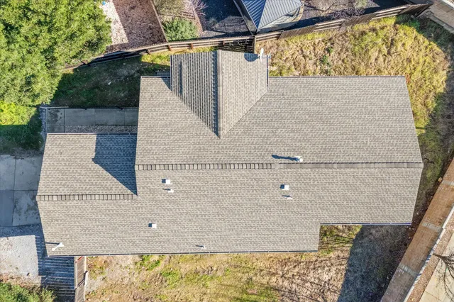 an aerial view of a house with a mountain