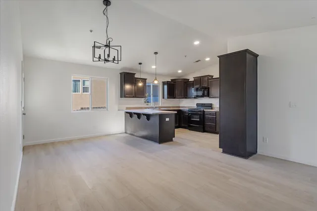 a view of kitchen with stainless steel appliances refrigerator stove microwave and cabinets
