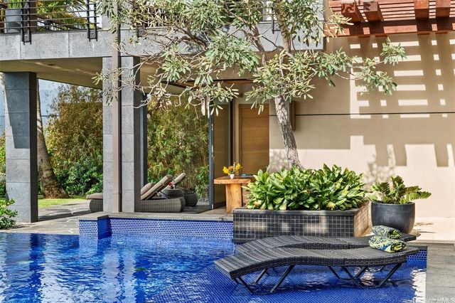 a view of a fountain in the patio with potted plants