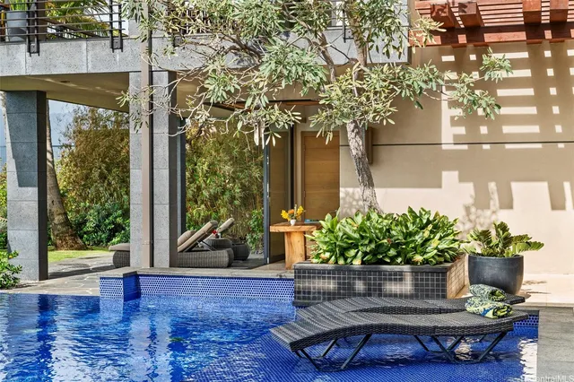 a view of a fountain in the patio with potted plants