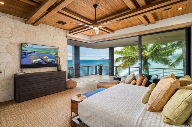 a bedroom with furniture and large window