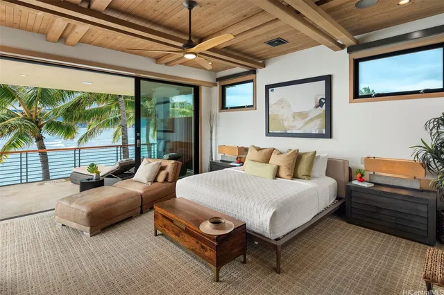 a bedroom with furniture and a large window