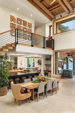 a living room with lots of furniture and a potted plant