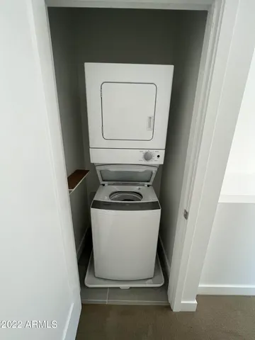 a utility room with wooden floor washer and dryer