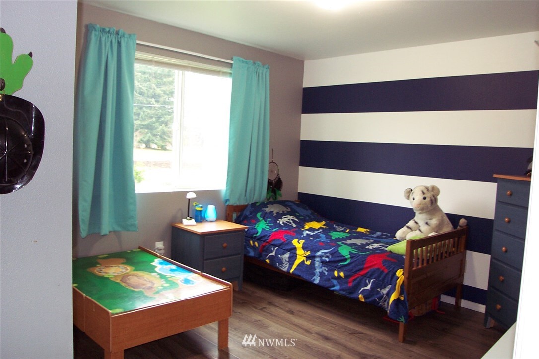 9222 176th Avenue Southwest Rochester, WA 98579 - Photo 13 of 21 a bedroom with a bed and a chair