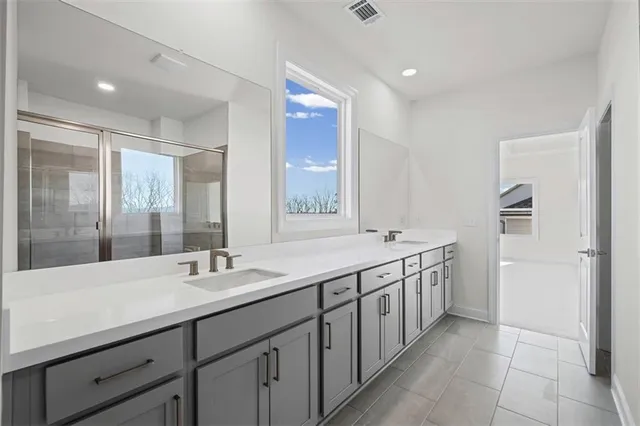 a spacious bathroom with a double vanity sink mirror and double