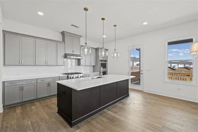 a kitchen with sink cabinets and wooden floor