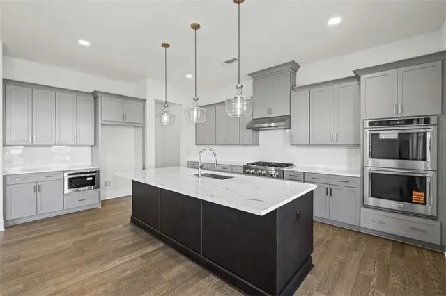 a kitchen with a stove a sink and a refrigerator