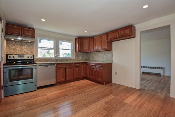 56 Bryant Road Holden, MA 01522 - Photo 3 of 24 a kitchen with granite countertop a stove and a refrigerator
