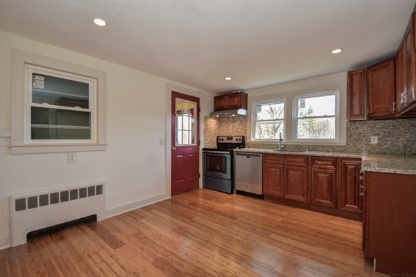 56 Bryant Road Holden, MA 01522 - Photo 6 of 24 a kitchen with stainless steel appliances granite countertop a refrigerator a sink dishwasher a stove with wooden cabinets and floor