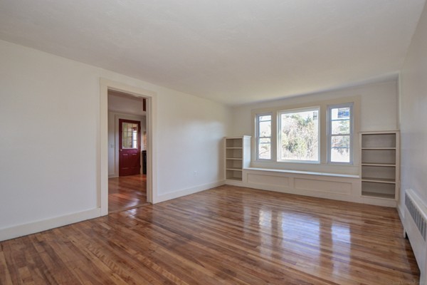 56 Bryant Road Holden, MA 01522 - Photo 7 of 24 an empty room with wooden floor and windows